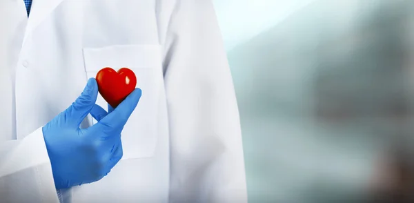 Doctor with heart in hospital — Stock Photo, Image