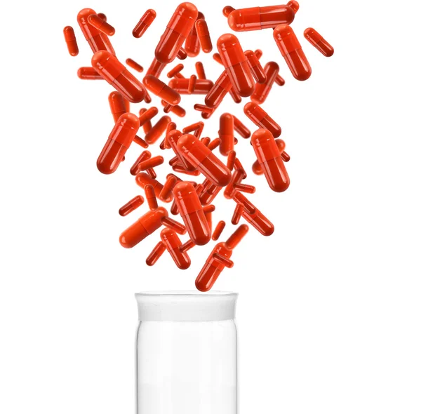 Pílulas médicas caindo em frasco de vidro, isolado em branco — Fotografia de Stock