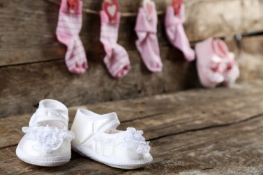 Cute toddler shoes on wooden background