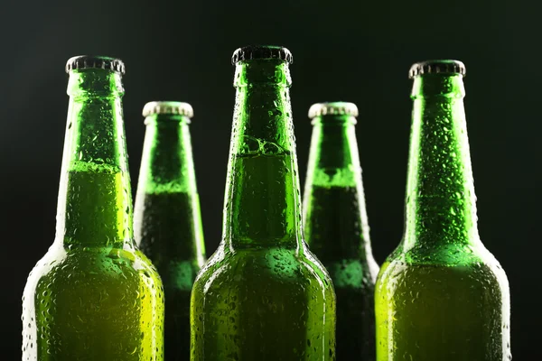 Glass bottles of beer on dark background — Stock Photo, Image