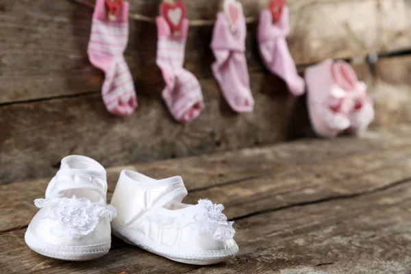 Cute toddler shoes on wooden background — Stock Photo, Image