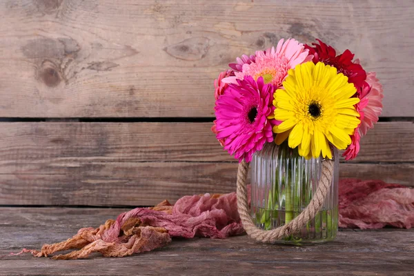 Still life with beautiful bright gerbera flowers on wooden background — Stock Photo, Image