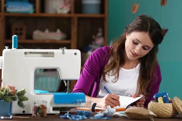 Beautiful young needlewoman in workshop — Stock Photo, Image