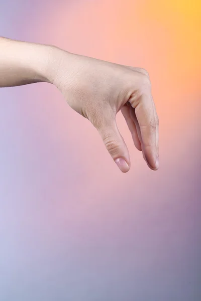 Kvinnlig hand på färgstarka bakgrund — Stockfoto
