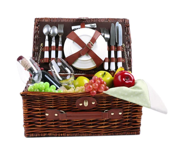 Wicker picnic basket with food, tableware and tablecloth — Stock Photo, Image