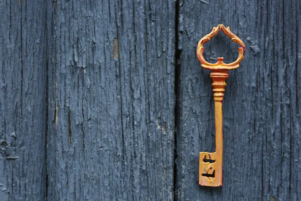 Old key on wooden antique door — Stock Photo, Image