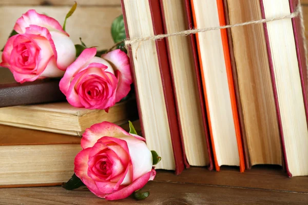 Tied books with pink roses — Stock Photo, Image