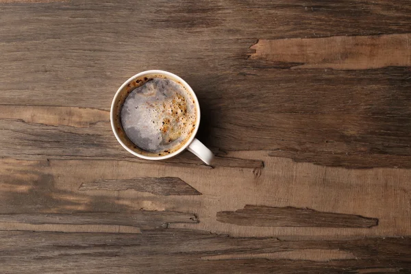 Tasse Kaffee auf Holztisch, Draufsicht — Stockfoto