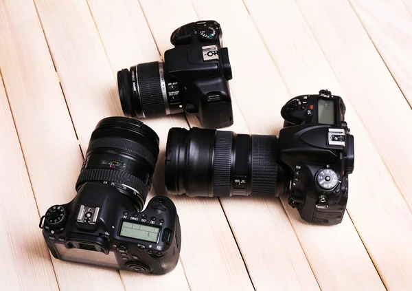 Modern cameras on wooden background — Stock Photo, Image