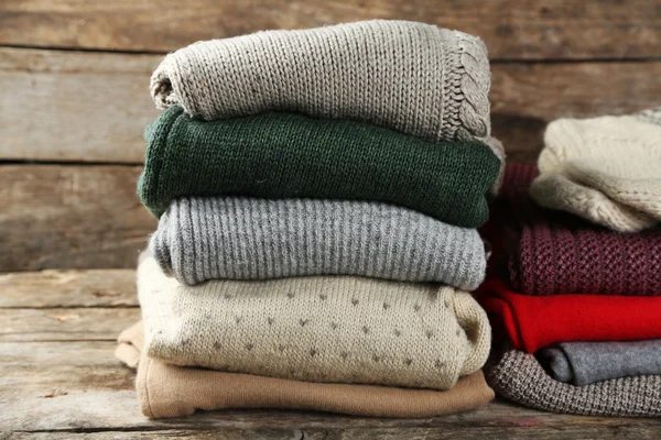 stock image Knitting clothes on wooden background