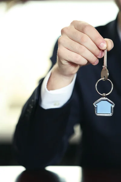 Businessman with keys in his hand in office, closeup — Stock Photo, Image