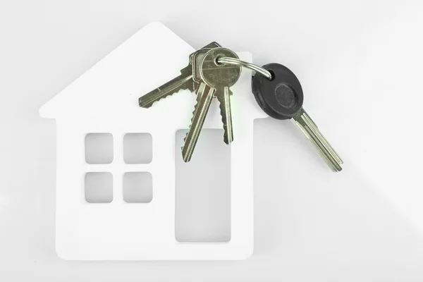 Keys with trinket on light background — Stock Photo, Image