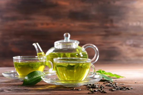 Cups of green tea on table on wooden background — Stock Photo, Image