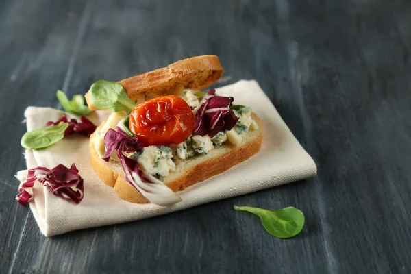 Tasty sandwich on wooden table, close up — Stock Photo, Image