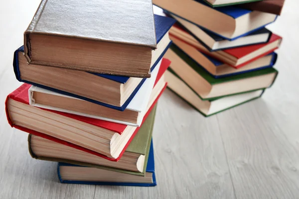 Stacks of books on wooden background — Stock Photo, Image