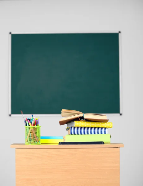 Wooden desk with stationery and chair — Stock Photo, Image