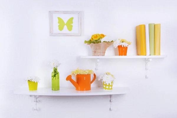 Flower on shelves on white wall — Stock Photo, Image