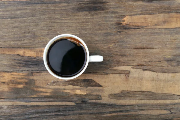 Cup of coffee on wooden table, top view — Stock Photo, Image