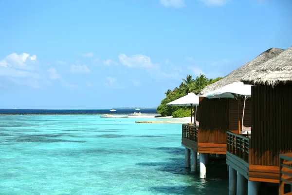 Water villas in ocean on blue sky background — Stock Photo, Image