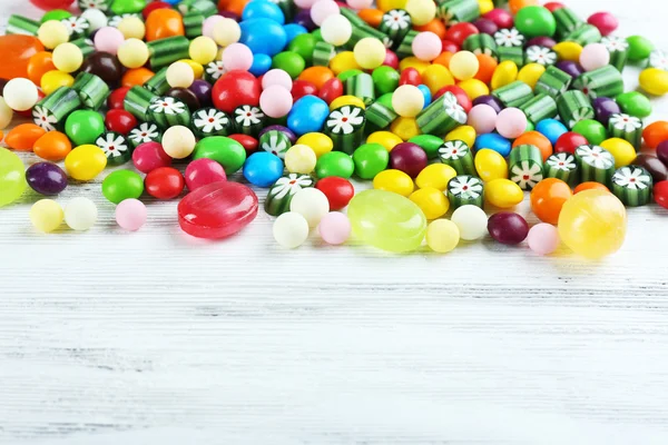 Colorful candies on wooden background — Stock Photo, Image