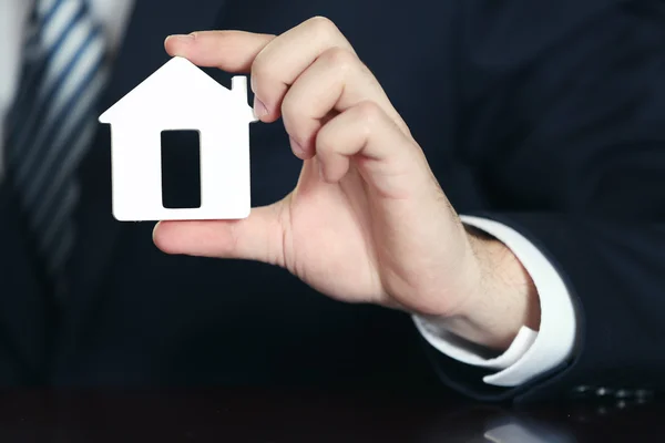 Male hand with trinket house — Stock Photo, Image