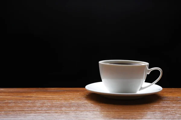 Cup of coffee on wooden table — Stock Photo, Image