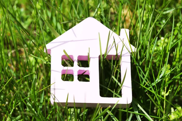 Toy house on grass background — Stock Photo, Image