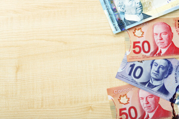 Canadian dollars on wooden table