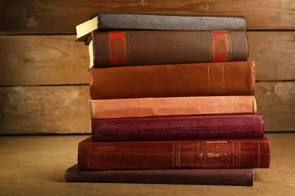 Old books on shelf, close-up, on wooden background — Stock Photo, Image