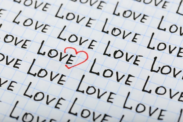 Words LOVE written on sheet of paper background — Stock Photo, Image