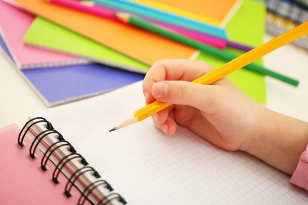 Kids hands drawing on notebook at desktop, closeup — Stock Photo, Image