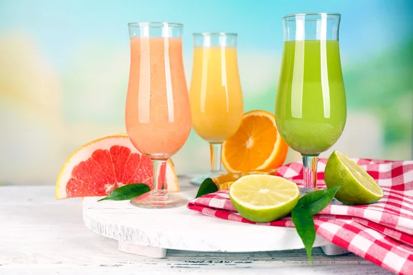 Fresh summer cocktails on wooden table on bright blurred background — Stock Photo, Image