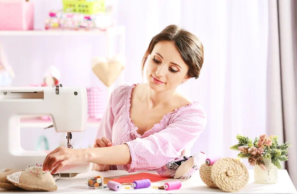 Beautiful young needlewoman in workshop — Stock Photo, Image