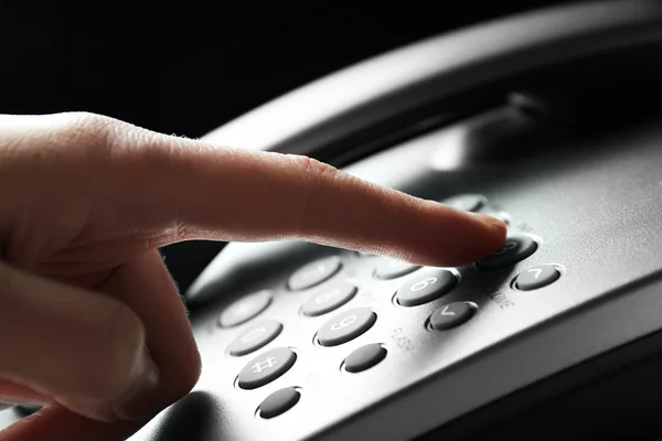 Finger pressing number button on telephone to make a call, close up — Stock Photo, Image