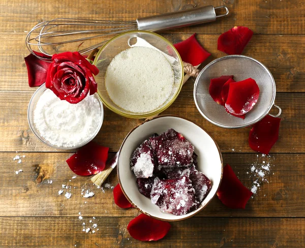 Making candied rose flower petals with egg whites and sugar, on wooden background — Stock Photo, Image