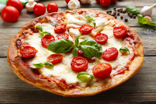 Delicious pizza with cheese and cherry tomatoes on wooden table, closeup — Stock Photo, Image