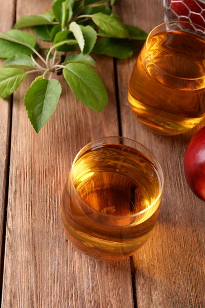 Vasos de jugo de manzana en la mesa de madera, primer plano — Foto de Stock