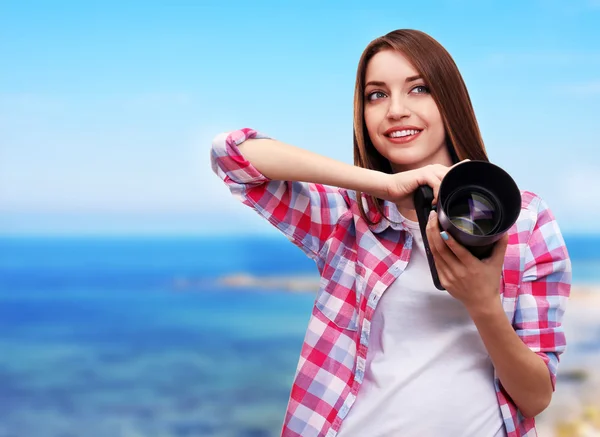 Joven fotógrafa tomando fotos sobre fondo natural — Foto de Stock