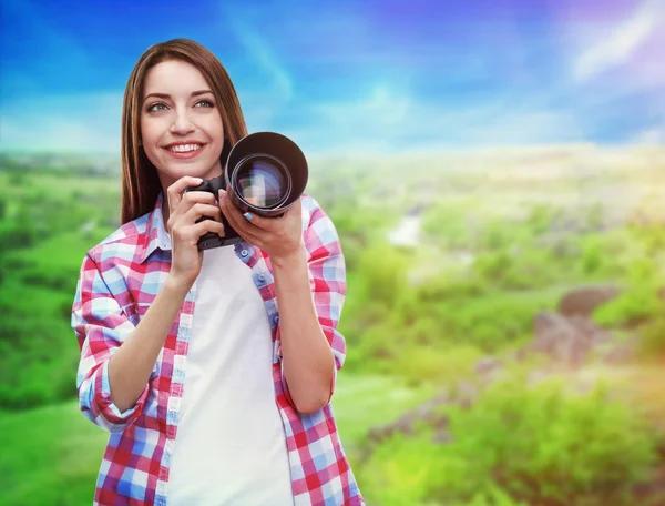 Young female photographer taking photos on nature background — Stock Photo, Image