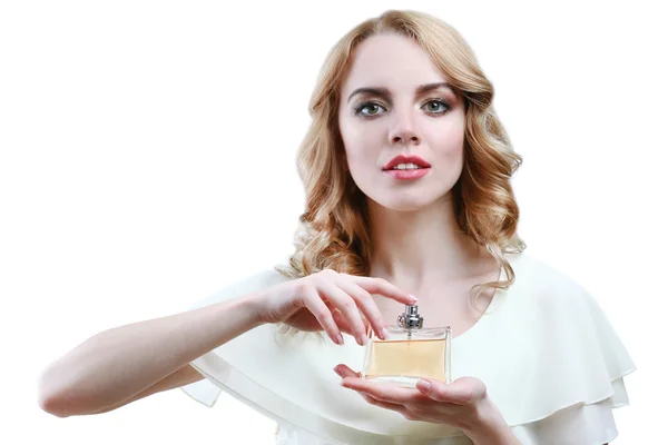 Beautiful young woman with perfume bottle isolate on white — Stock Photo, Image