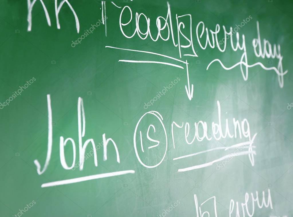Teacher hand writing grammar sentences — Stock Photo © belchonock #74137567