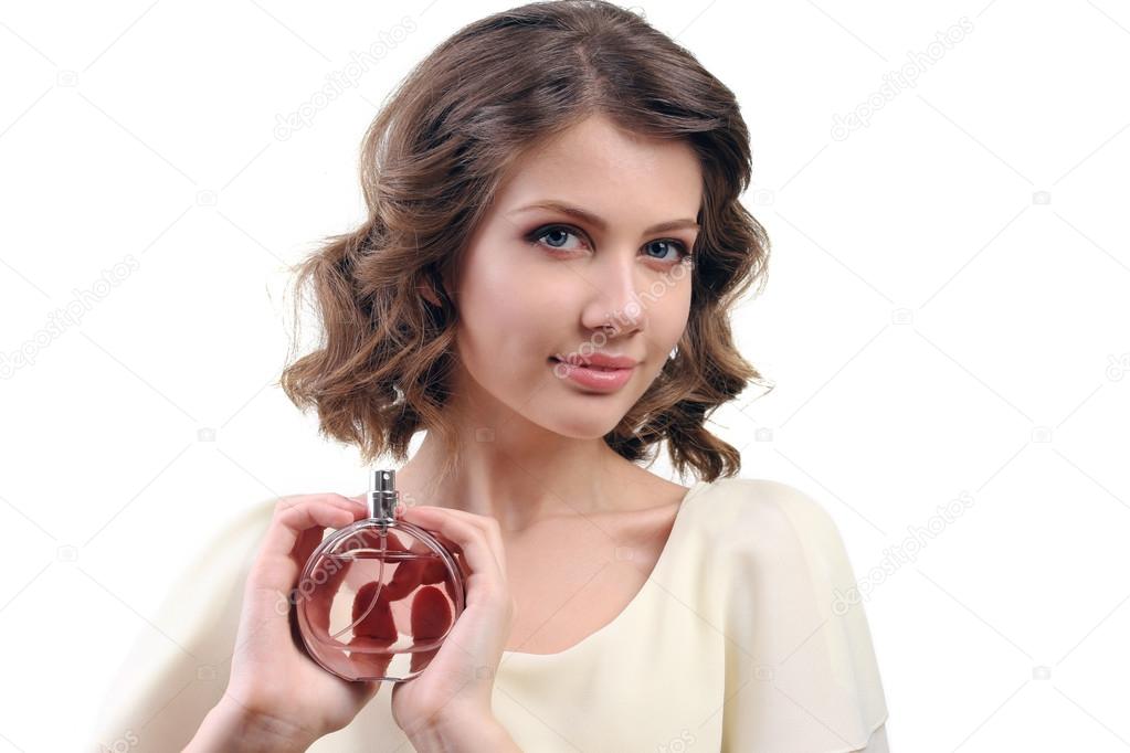 Beautiful woman with perfume bottle