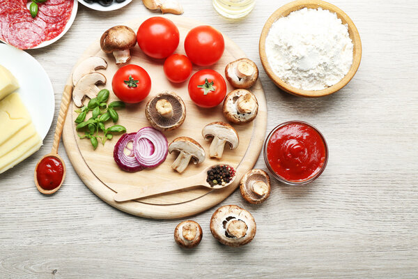 Ingredients for cooking pizza on wooden table, top view