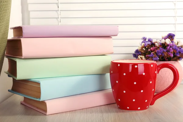 Libri, tazze e piante sul davanzale di legno, primo piano — Foto Stock