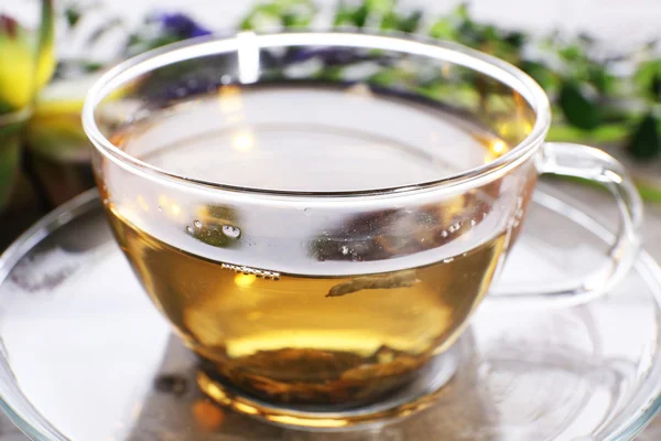 Tasse Kräutertee mit Blumen auf Holztisch, Nahaufnahme — Stockfoto