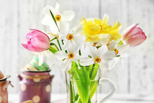 ガラスのマグと木製の背景の色でおいしいマカロンに春の花束 — ストック写真