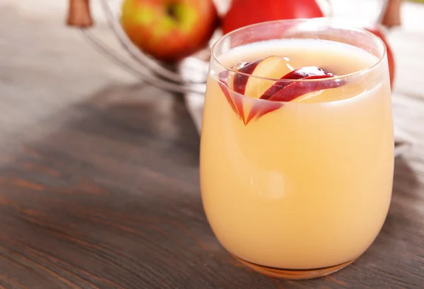 stock image Glass of apple cider with fruits on wooden background