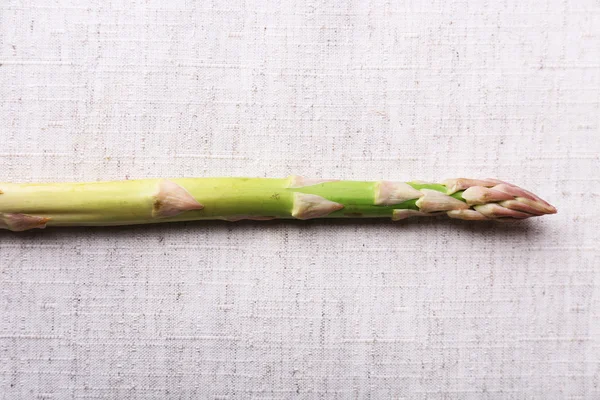 Fresh asparagus on sackcloth background — Stock Photo, Image