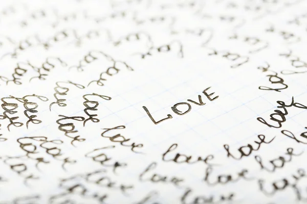 Words LOVE written on sheet of paper background — Stock Photo, Image