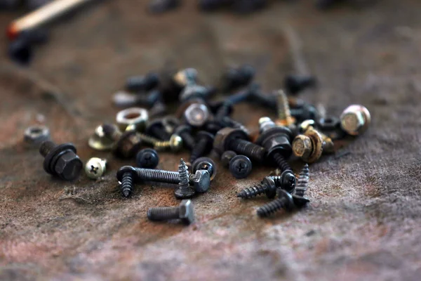 Heap of nuts and bolts on table close up — Stock Photo, Image